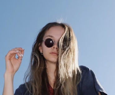 Woman adjusting sunglasses