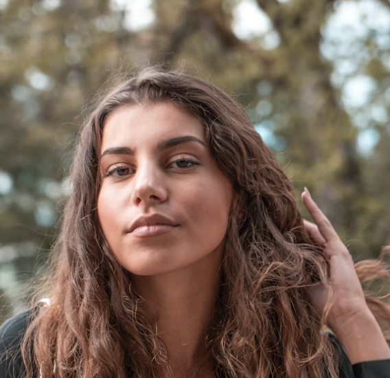 Woman touching hair outdoors